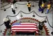  ?? JAE C. HONG — THE ASSOCIATED PRESS ?? A Vietnamese group from Orange County pays their respects near the casket of Sen. John McCain during a viewing at the Arizona Capitol on Wednesday in Phoenix.