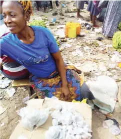  ??  ?? This woman sells carbide close to where bananas and plantains are sold at Zuba fruit market.