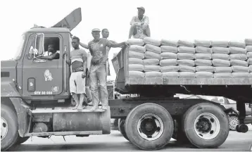  ??  ?? Labourers stand on top of a trailer transporti­ng cement along Ajah-Lagos expressway in Nigeria’s commercial capital Lagos. — Reuters photo