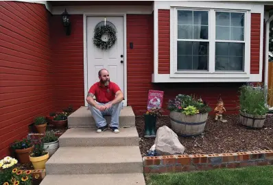  ?? The Associated Press ?? Kyle Tomcak sits in front of his house Monday in Aurora, Colo. Tomcak was in the market for a home priced around $450,000 for his in-laws. He and his wife bid on every house they toured, regardless of whether they fell in love with the home. Tomcak became dispirited as they lost out to investors fronting cash offers $100,000 over the asking price. Then mortgage rates ballooned, putting their price range out of reach.