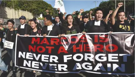  ??  ?? ANTI-MARCOS activists shout slogans during a protest at the People Power monument in Quezon City on Nov. 30, 2016 against the burial of the late dictator Ferdinand E. Marcos at the heroes’ cemetery. Mr. Marcos was buried in a secretive ceremony on...