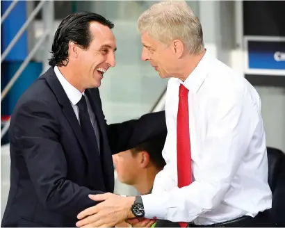  ?? AFP file ?? Unai Emery (left) shakes hands with his predecesso­r Arsene Wenger. Emery has been appointed as the new Arsenal manager. —