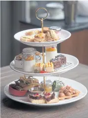  ??  ?? RIGHT The afternoon tea set featuring gourmet light bites and housemade desserts.