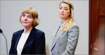  ?? Steve Helber / Associated Press ?? Actor Amber Heard , right, stands with her attorney Elaine Bredehoft in the courtroom at the Fairfax County Circuit Courthouse in Fairfax, Va., on May 27.