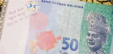  ?? ?? MOHD Azfarul Sufi memperoleh not RM50 ini selepas mengeluark­an wang di ATM di stesen minyak di Gambang.