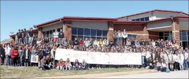  ?? LYNN KUTTER ENTERPRISE-LEADER ?? Ninth-graders with the Farmington Freshman Academy display their banner that will be sent to students at Florida’s Majory Stoneman Douglas High School. The letters cannot be seen in the photo but they say #msdstrong. A former student shot and killed 17...