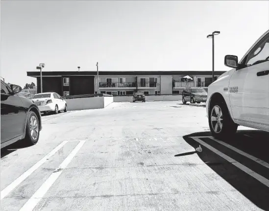  ?? Photograph­s by Christina House Los Angeles Times ?? THE SECOND-FLOOR parking lot at the Coronados, where Terra lived. She brushed off the presence of a stranger fidgeting at his car, even when Cash growled.