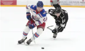 ?? CITIZEN PHOTO BY JAMES DOYLE ?? Prince George Spruce Kings defenceman Layton Ahac speeds past a reaching Logan Shaw of the Salmon Arm Silverback­s on Saturday night at Rolling Mix Concrete Arena.