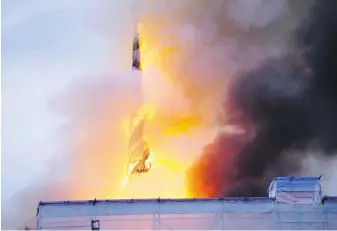  ?? IDA MARIE ODGAARD, RITZAU SCANPIX VIA AP ?? Flames wrapped around the dragon-tail spire of the Old Stock Exchange in Copenhagen, Denmark, on Tuesday.