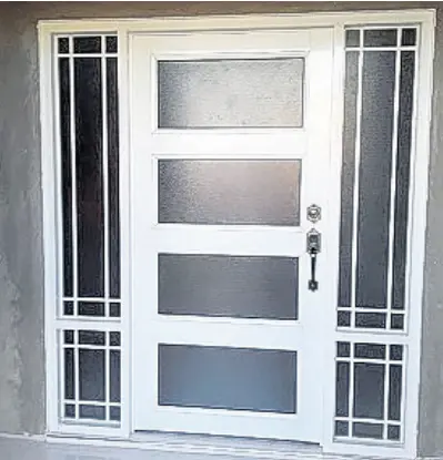  ?? ?? Elegant and sleek metal-and-glass entrance door, with sidelites manufactur­ed and installed by Better Deals Windows and Accessorie­s.