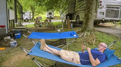  ?? Steve Mellon/Post-Gazette ?? Brian Meyers, of Dover, Ohio, enjoys a quiet moment at Bear Run Campground near Portersvil­le.