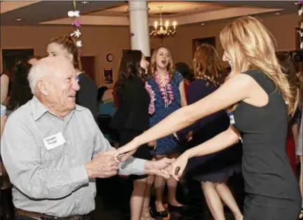  ?? JESI YOST — DIGITAL FIRST MEDIA ?? Kenneth Snyder shows Boyertown Area High School senior Charlotte Calautti a few dance moves at Senior-Senior Prom held at The Center at Spring Street.