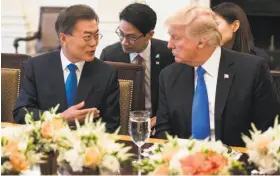  ?? Kevin Dietsch / Bloomberg ?? Moon Jae-in, South Korea’s new leader, visits with President Trump before their dinner in the State Dining Room at the White House.