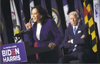  ?? Olivier Douliery / AFP via Getty Images ?? Democratic presidenti­al nominee Joe Biden listen to his vice presidenti­al running mate, Sen. Kamala Harris, speak during their first press conference together in Wilmington, Del., on Wednesday