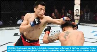  ?? — AFP ?? HOUSTON: This handout from Zuffa LLC via Getty Images taken on February 4, 2017 and released on October 16, 2018 shows Chan Sung-jung of South Korea (L) punching Dennis Bermudez of the US in their featherwei­ght bout during the UFC Fight Night event in Houston, Texas.