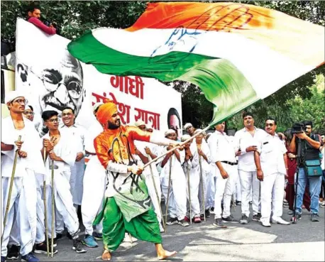  ?? PRAKASH SINGH/AFP ?? Indian National Congress party supporters mark the 150th anniversar­y of the birth of independen­ce leader and peace icon Mahatma Gandhi in New Delhi on Wednesday.