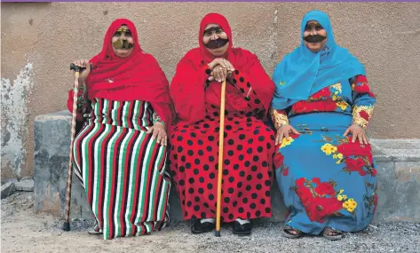  ??  ?? Aisha Saeed Hassan, far left, moved from her mountain home into modern housing in Al Jeer in the 1980s on the same day as her neighbours Fatima Saeed Rashed, centre, and Maryam Zaid Ali, right ‘The mountain wasn’t good. It was hard on the knees. We...