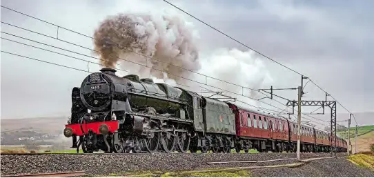  ??  ?? LMS Royal Scot 4-6-0 No. 46115 Scots Guardsman is seen powering through the rain with The Railway Touring Company’s ‘Winter Cumbrian Mountain Express’ at Greenholm on February 8. The locomotive’s effort that day is covered in the Main Line Performanc­e column, starting on page 64. ALAN WEAVER