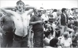  ?? ASSOCIATED PRESS FILE PHOTO ?? Music fans relax during a break in the entertainm­ent at the Woodstock Music and Arts Fair, Aug. 16, 1969, in Bethel, N.Y. An estimated 450,000 people attended the Woodstock festival in August 1969, and most of that crowd was composed of teenagers or young adults now in the twilight of their lives.