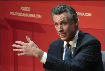  ?? RICH PEDRONCELL­I — THE ASSOCIATED PRESS ?? California Gov. Gavin Newsom speaks during an interview with Politico in Sacramento on Tuesday. Newsom said the state will intervene in a federal case that has barred San Francisco from cleaning up homeless encampment­s.