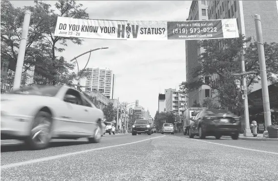  ?? JASON KRYK ?? A banner from AidsWindso­r.org promoting testing for HIV and sexually transmitte­d infections is displayed over Ouellette Avenue in downtown Windsor on Wednesday.