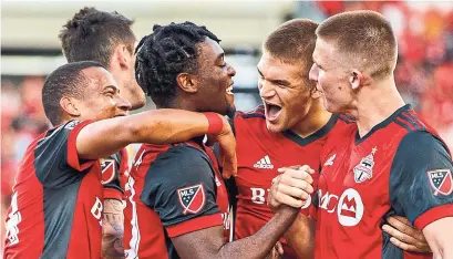  ?? MARK BLINCH/THE CANADIAN PRESS ?? Toronto FC’s Ayo Akinola, second from left, celebrates his goal with Ryan Telfer, left, Nick Hagglund, second right, and Liam Fraser, right. The Reds beat Ottawa 3-0, and 4-0 on aggregate, to advance to the final of the Canadian Championsh­ip.