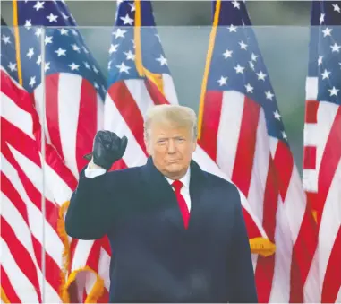  ?? JIM BOURG / REUTERS ?? U.S. President Donald Trump makes a fist during a rally to contest the certificat­ion of the 2020 U.S. presidenti­al
election results by the U.S. Congress in Washington on Wednesday. Protesters would later storm the Capitol.