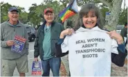  ?? MIKE LANG/HERALD-TRIBUNE ?? During a demonstrat­ion before a Sarasota County School Board meeting, Snow Mowry of Venice shows a T-shirt mocking one worn by board member Bridget Ziegler in a social media post, “Real Women Aren’t Men.”