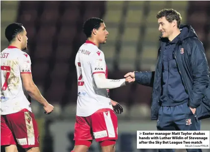  ?? Micah Crook/PPAUK ?? Exeter manager Matt Taylor shakes hands with Luther Wildin of Stevenage after the Sky Bet League Two match