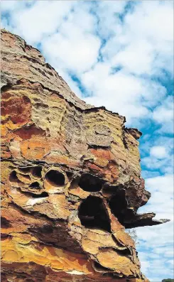  ??  ?? Boldly hued cliffs are pocked with caves in Isalo National Park. They are considered sacred because members of the Bara tribe temporaril­y keep their dead in the caves before entombing them.