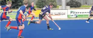  ?? PHOTO: HAMISH MACLEAN ?? Southern pride . . . Gore High School’s Andrew Allan blows past St Peter’s College defenders as the Gore schools clash in a hockey match at Oamaru yesterday.