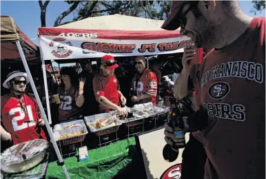  ?? Photos by Michael Short / The Chronicle ?? The crew of Smokin’ J’s Tailgate, which serves a wide-ranging buffet of pregame fare, won last year’s 49ers Tailgater of the Year award and aim to defend their award in the team’s last season at Candlestic­k Park.
