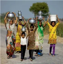  ?? Reuters file ?? PRECIOUS WATER: Village women and girls carry water at Fangadi Village on the outskirts of Ahmedabad in India. —