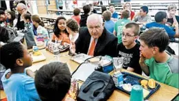  ?? CAROLYN KASTER/AP ?? Agricultur­e Secretary Sonny Perdue eats lunch Monday with students in Leesburg, Va.