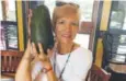  ?? Mary Lou Knurek, via The Associated Press ?? Pamela Wang shows off the giant avocado she found while she was on a walk in Hawaii.