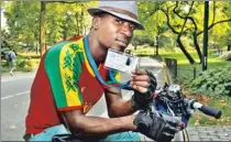  ??  ?? EASY RIDER: New York pedicabby Mady Kalmogo shows his license — from the nation of Burkina Faso.