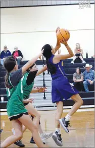  ?? Westside Eagle Observer/MIKE ECKELS ?? Lady Bulldog Daisy Fuentes (right) goes for a layup during the Decatur-Quinton, Okla., junior high basketball contest in Jay, Okla., on May 27. During the June 13-14 Bentonvill­e junior high basketball camp, Fuentes led Decatur with an 11-game total of 57 points.