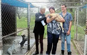  ?? Picture: ABONGILE SOLUNDWANA ?? ADOPTION: Local resident Dean Jones, left, has given a new home to two dogs from the SPCA, which is set to close next week. With him are Rose Joubert and her son Stephen, who was considerin­g adopting a cat.