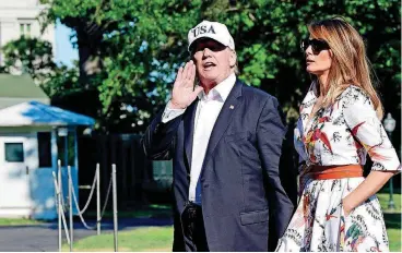  ?? [AP PHOTO] ?? President Donald Trump responds to a question Sunday about his pick for the Supreme Court as he walks with first lady Melania Trump on the South Lawn of the White House in Washington after returning from Bedminster, N.J., where they spent the weekend.
