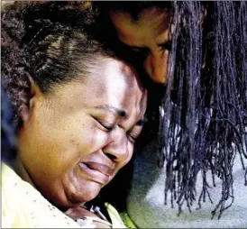  ?? The Associated Press ?? Duck boat accident survivor Tia Coleman is comforted by her sister Leeta Bigbee at Cox Medical Center Branson on Saturday. Coleman lost nine family members in the accident Thursday on Table Rock Lake, which left over a dozen people dead.