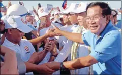 ?? TANG CHHIN SOTHY/AFP ?? Prime Minister Hun Sen greets supporters of the CPP on the last day of last year’s commune election campaign.