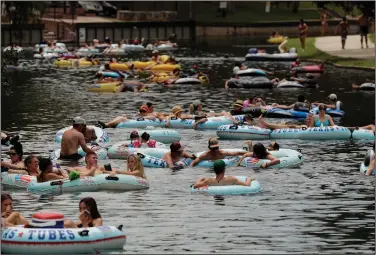  ?? (AP/Eric Gay) ?? Tubers crowd the Comal River in New Braunfels, Texas, on Thursday despite the recent spike in coronaviru­s cases.