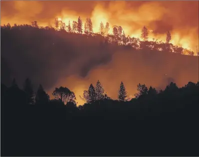  ??  ?? A wildfire burns along a ridgetop near Big Bend in Northern California, where 23 people have been killed.