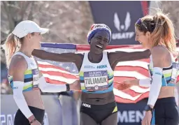  ?? KIRBY LEE/USA TODAY SPORTS ?? Aliphine Tuliamuk of Flagstaff won the U.S. Olympic Marathon Trials women's title. She celebrates with her Northern Arizona Elite teammates Kellyn Taylor, left, and Stephanie Bruce, who also were in the top 10.