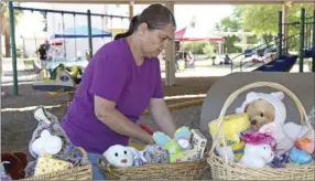  ?? WILLIAM ROLLER PHOTO ?? Heather White, founder of the nonprofit, Cody’s Closet and organizer of the third annual Easter Egg Hunt, prepares gift basket prizes at Sunbeam Lake in Seeley on Saturday.