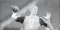  ?? By Michael Conroy, AP ?? Time-tested skills: Brandon Weeden throws at the NFL scouting combine Sunday in Indianapol­is. He is the oldest attendee.