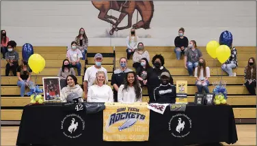  ?? Tara Pell/Special to News-Times ?? To the next level: Smackover senior Karis Robinson (center) signed to play softball at SAU Tech last week. The pitcher has helped the Lady Bucks to a 20-2 record this season.