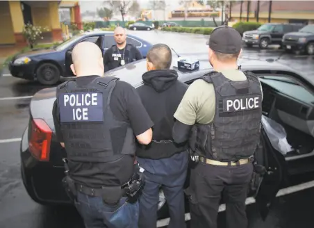  ?? Charles Reed / U.S. Immigratio­n and Customs Enforcemen­t 2017 ?? Immigratio­n and Customs Enforcemen­t police arrest a man in an operation in Los Angeles aimed at undocument­ed immigrants in 2017. California law prohibits law enforcemen­t agencies in the state from cooperatin­g with ICE in some instances.