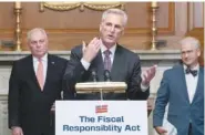  ?? AP PHOTO/JOSE LUIS MAGANA ?? House Speaker Kevin McCarthy, R-Calif., speaks Wednesday as House Minority Whip Rep. Steve Scalise, R-La., left, and Rep. Patrick McHenry, R-N.C., listen at a news conference after the House passed the debt ceiling bill at the Capitol in Washington.