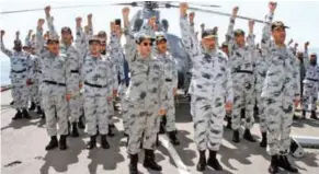 ?? - Express Tribune/Pakistan Navy ?? COMBAT READINESS: Commander of Pakistan fleet Vice Admiral Arifullah Hussaini chants the national slogan with the officers and men of Navy.
